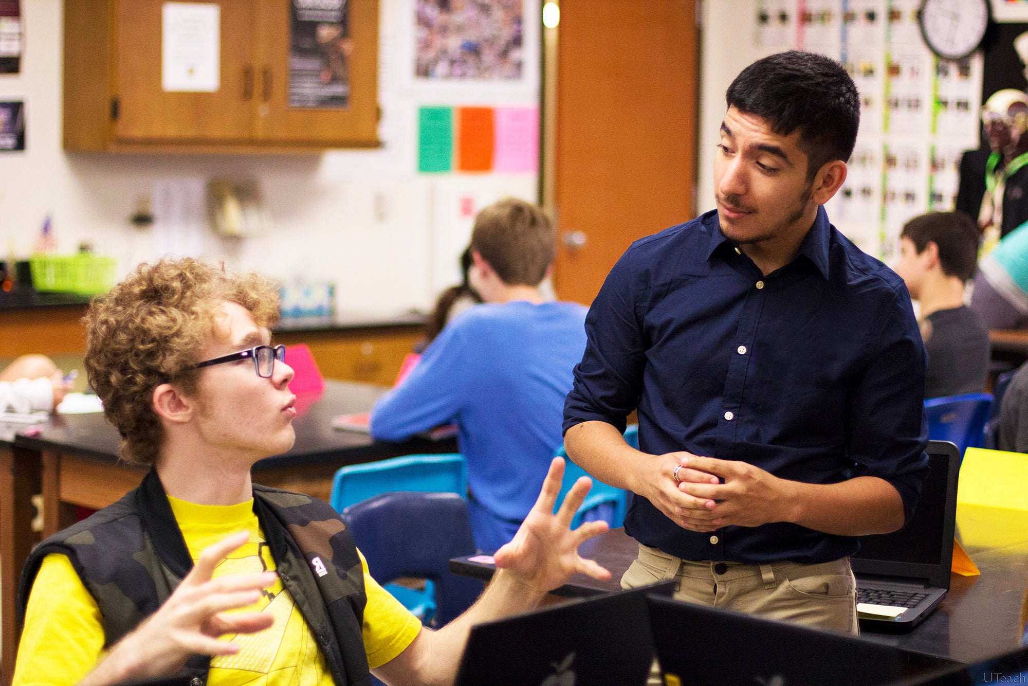 student and teacher having a discussion